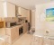 Full equipped kitchen with an adjoining living area , dining table, stove, oven, large fridge with freezer compartment, kettle, toaster, washing machine, microwave, nespresso machine 