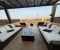 Private roof terrace with sun loungers and shaded seating area.