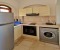 Fully equipped kitchen with stove, oven, washing machine and kettle