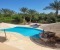 Private pool with sun loungers and poolside bar