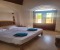 Bedroom 1 with double bed and terrace with pool view