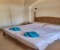 Bedroom 2 with double bed, bathroom en-suite with shower and balcony with pool view