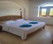 Bedroom 2 with double bed, bathroom en-suite with shower and balcony with pool view