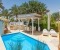 Beautiful terrace with pool, sun beds, dining table, lounge and outdoor kitchen