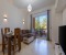 Living room with large Smart TV and access to the balcony