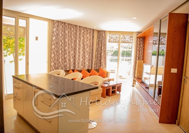 Living room and open kitchen with access to balcony 