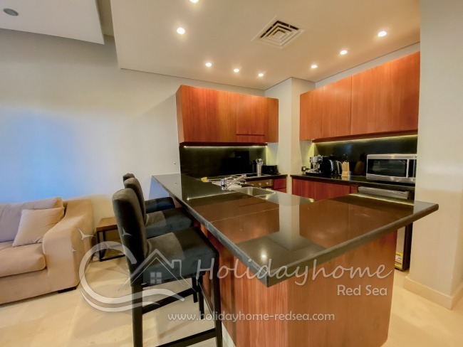 Fully equipped kitchen with a washing machine, dishwasher, kettle, coffee machine, and toaster