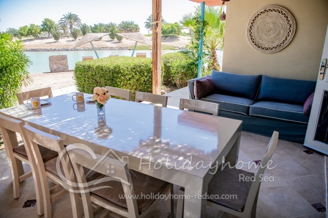 Large dining table on the outside terrace with sofa 
