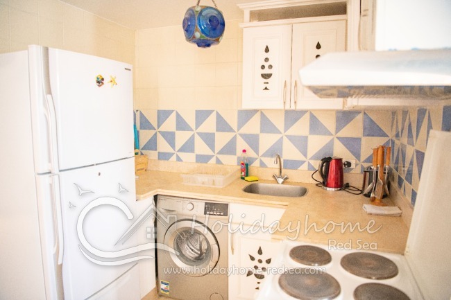 Fully equipped kitchen with washing machine, kettle and toaster