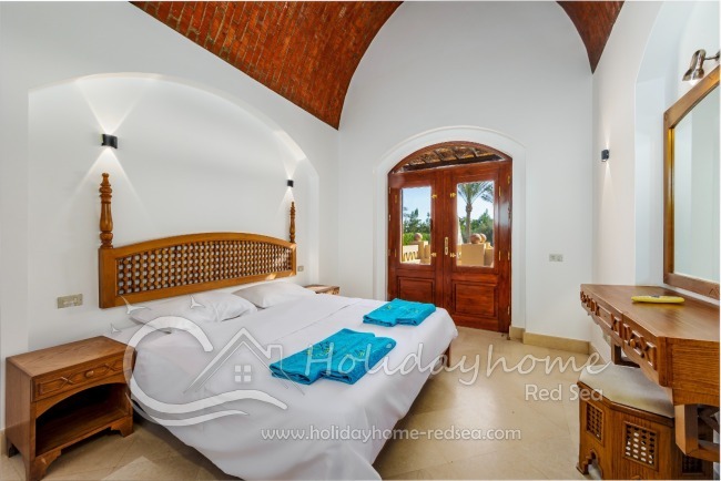 Bedroom 2 with double bed and terrace with pool view