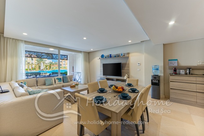 Large dining table and beautiful, spacious living room with smart TV