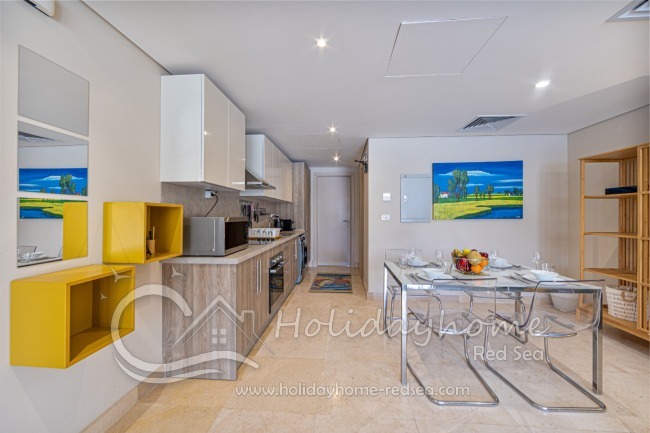 Full equipped kitchen with an adjoining living area , dining table, stove, oven, large fridge with freezer compartment, kettle, toaster, washing machine, microwave, nespresso machine 