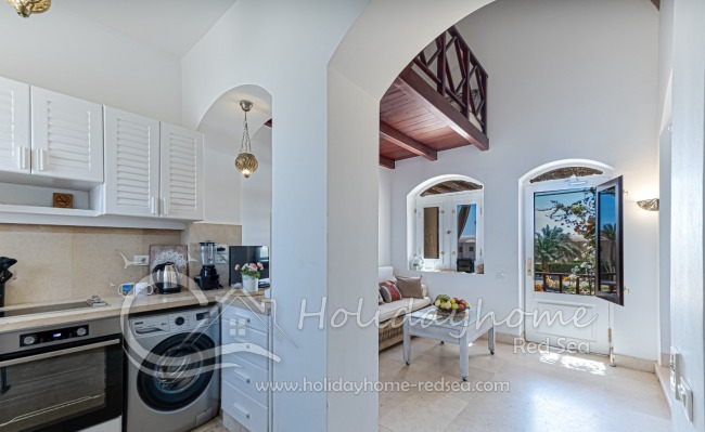 Fully equipped kitchen with dining counter with bar chairs 