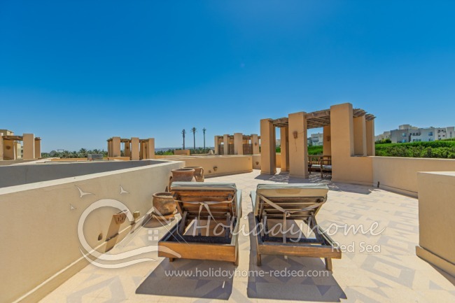 Large roof terrace with seating area and sun beds