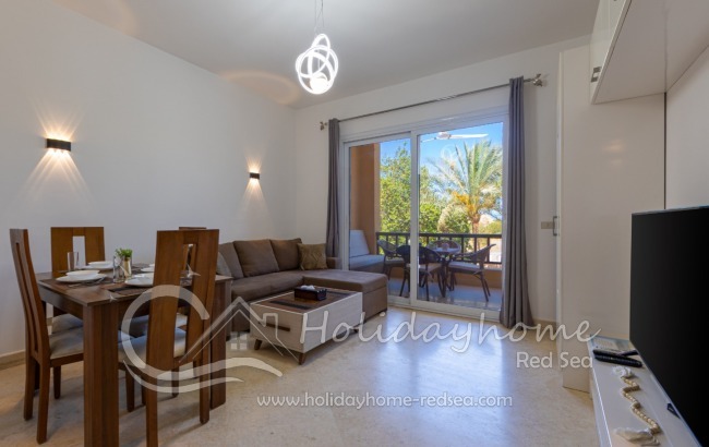 Living room with large Smart TV and access to the balcony