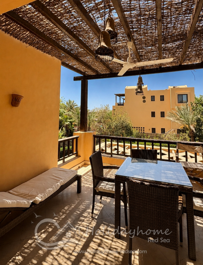 Large balcony with table, chairs and sun lounger