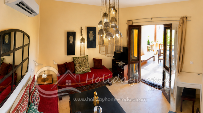 Oriental living room with small working desk and access to the large balcony